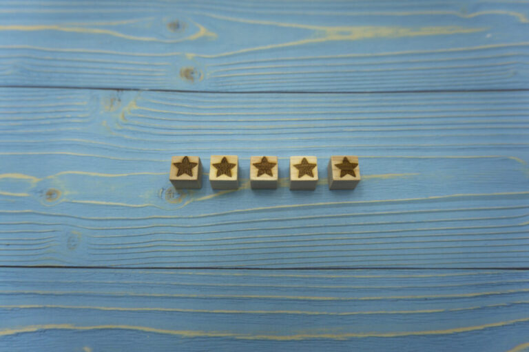 青いウッドデッキの中央に5つ星のウッドキューブを並べた口コミや評価の背景